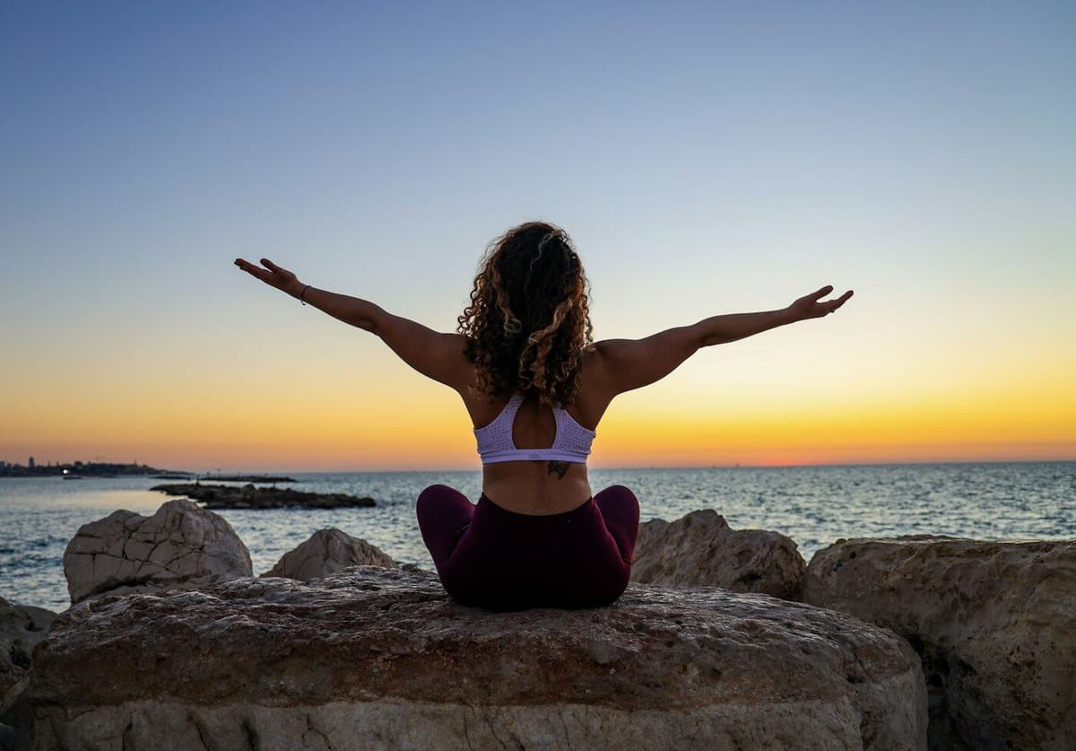 Praticante de yoga ao pôr-do-sol